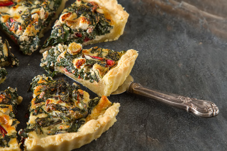 Homemade cheese Quiche egg for brunch with spinach and chard.
