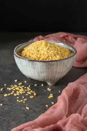 Bulgur on a dark background. Vegetarian Oriental foodの写真素材