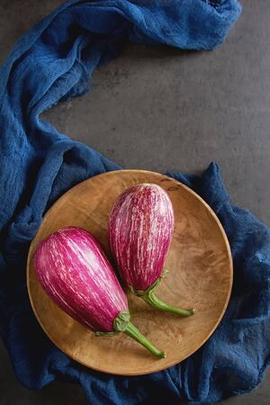 Healthy and tasty purple eggplants on a dark background.の写真素材