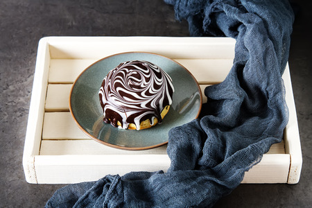 Delicious donuts with a filling and glaze. Fast food. Dark background