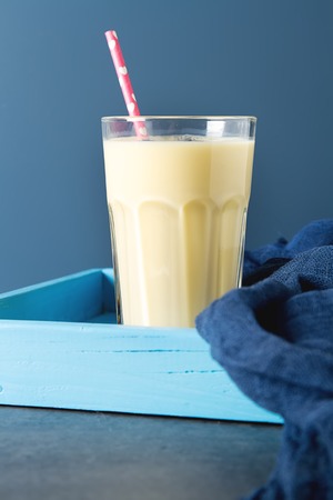 Milk shake is banana with blueberries. Dark background. Space for textの写真素材