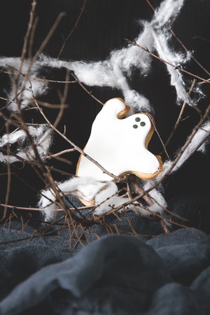 Sweet Halloween. Cookies in the form of ghosts, leaves and pumpkins. Dark background. Space for textの写真素材
