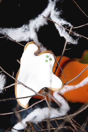 Sweet Halloween. Cookies in the form of ghosts, leaves and pumpkins. Dark background. Space for textの写真素材