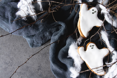 Sweet Halloween. Cookies in the form of ghosts, leaves and pumpkins. Dark background. Space for textの写真素材