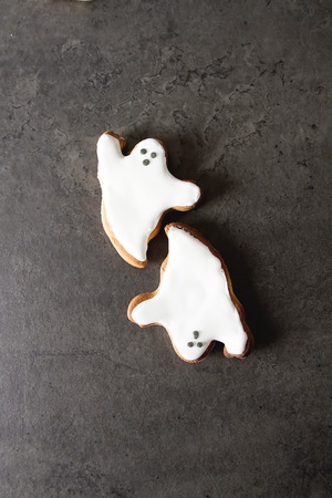 Sweet Halloween. Cookies in the form of ghosts, leaves and pumpkins. Dark background. Space for textの写真素材