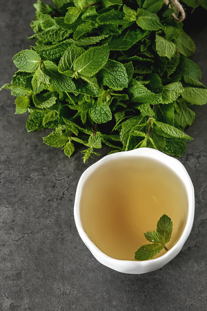 Fresh mint leaves in tea. Italian herbs. Dark backgroundの写真素材