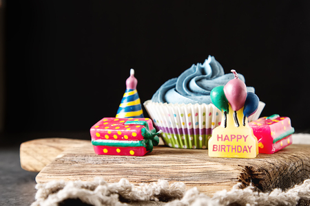 Capecake, Muffin with blue cream. Birthday and wedding. A delicious holiday. Dark backgroundの写真素材