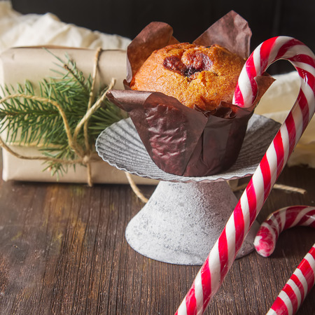 Blueberry muffins and fresh fruit, a cup of black coffee, caramel horn. Tasty dessert. Light breakfast. Christmas. Dark backgroundの写真素材