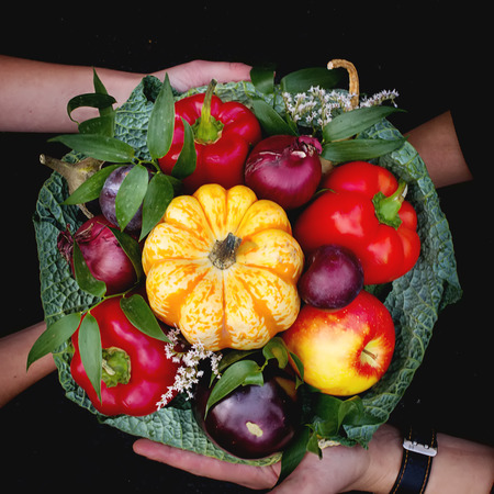 The original unusual edible bouquet of vegetables and fruits in a hands