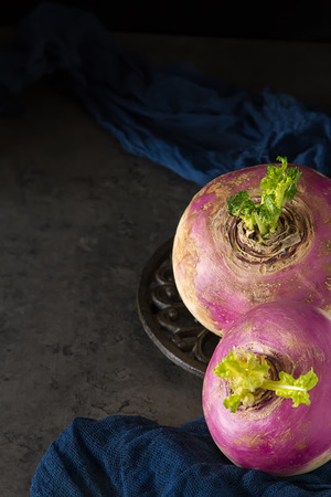 Ripe turnip. Dark background. Vegetarian food.の写真素材