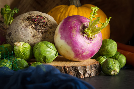 Ripe turnips, beets, cabbage, pumpkin and parsley. Dark background. Vegetarian foodの写真素材