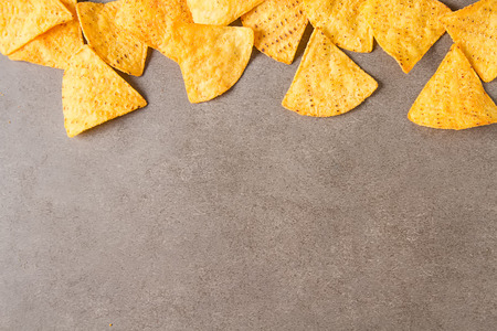 Snack for a party, chips with a tortilla, nachos with sauces: salsa with tomatoes, cheese and...