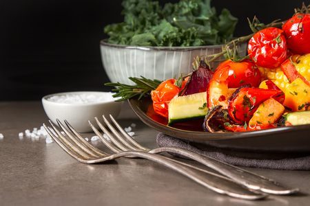 Grilled vegetables with salt and spices. Dark background. Fast food in the summer. A vegan picnicの写真素材