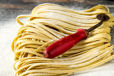Homemade italian tagliatelle with flour. Dark backgroundの写真素材