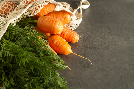 Young carrots. Fresh vegetarian products. Delicious food for children. Dark backgroundの写真素材