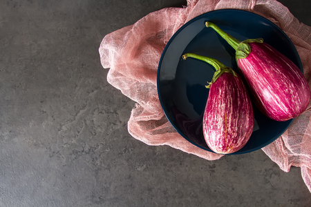 Healthy and tasty purple eggplants on a dark background.の写真素材
