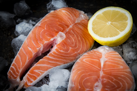Steak of salmon on ice. Fresh fish. Dark backgroundの写真素材