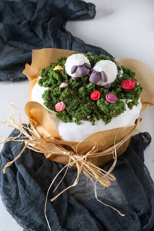 Spring holiday Easter, cake with cream, animals from mastic. Light background