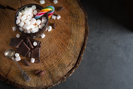 Cocoa with marshmallow and caramel. New Year. Dark background
