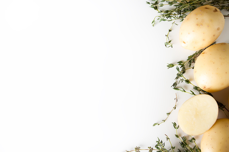 Potato with a thyme on a white background. Food conceptの写真素材