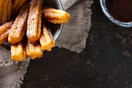 Traditional Mexican dessert churros with chocolate sauce. Dark backgroundの写真素材