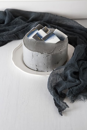 Birthday cake with a gray cream. White backgroundの写真素材