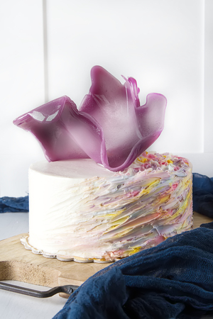 Birthday cake with pink caramel. White backgroundの写真素材