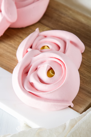 meringue in the form of a pink flower. Light backgroundの写真素材
