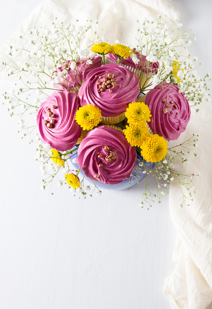 A cupcake for a holiday with flowers. Light backgroundの写真素材