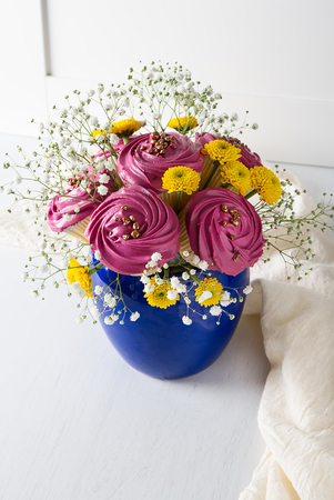 A cupcake for a holiday with flowers. Light backgroundの写真素材