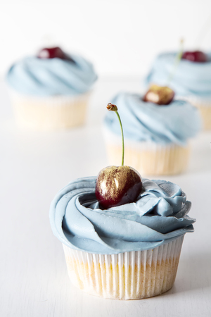 A cupcake for a holiday with flowers. Light backgroundの写真素材