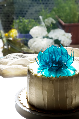 A cake for a holiday with flowers. Light backgroundの写真素材