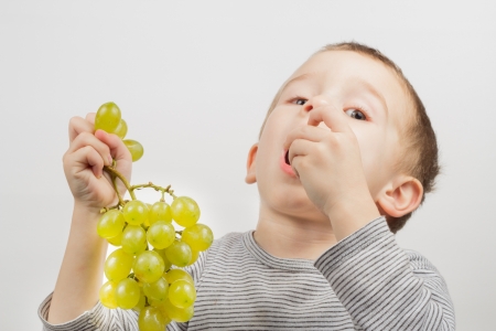 little boy with grapesの写真素材