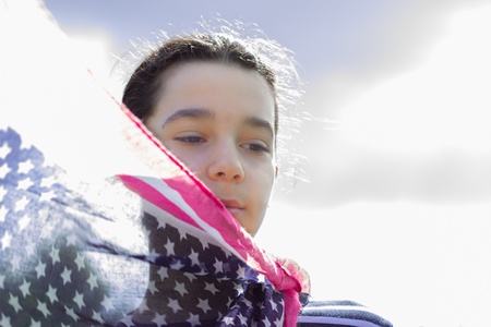 young girl blue sky and American flag scarf