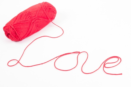 red yarn thread isolated on white backgroundの写真素材
