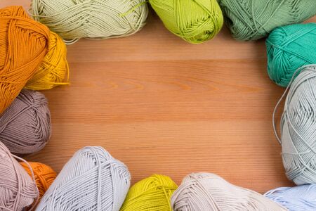 Colorful yarn balls in wood table