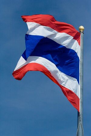Image of waving Thai flag of Thailand with blue sky background.の写真素材