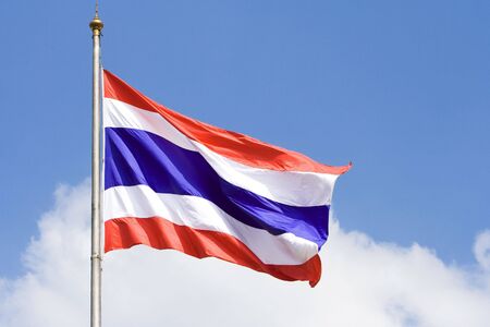 Image of waving Thai flag of Thailand with blue sky background.の写真素材
