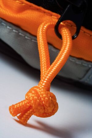 Detail photo texture of the orange rope and knot on a bag.の写真素材