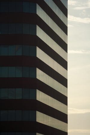Angled shot of an office building with shiny glass.