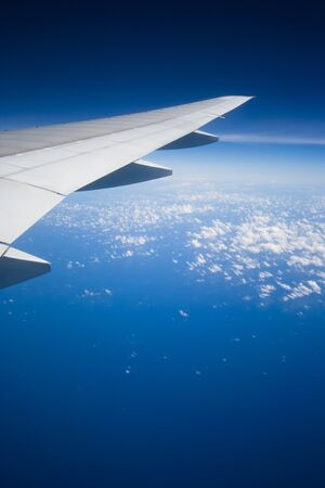 A view of blue ocean and white cloud from airplane の写真素材