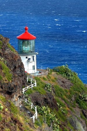 Two workmen paint the exterior of the Makapuu Point Lighthouse on the Island of Oahu, Hawaii. Damages from wind and rain have eroded the exterior of the historic landmark. Two workmen paint the exterior of the Makapuu Point Lighthouse on the Island of Oahu, Hawaii. Damages from wind and rain have eroded the exterior of the historic landmark.