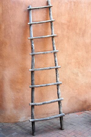 Old ladder leans against the wall of an adobe shop in "Old Town" in Albuquerque, New Mexico.  の写真素材