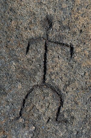 Art work of an early Hawaiian is preserved in this petroglyph found on the Big Island of Hawaii.  Drawing shows a man scratched in stone.の写真素材