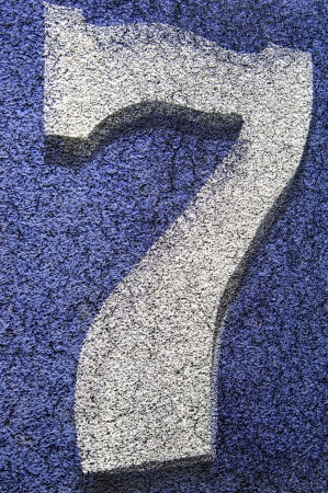 The number 7 is spray painted onto a commercial grade surface at a football field   The background...