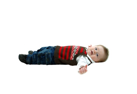 Sweet and contented baby lays on all white floor   He is cooing happily   Image is full length on white and isolated の写真素材