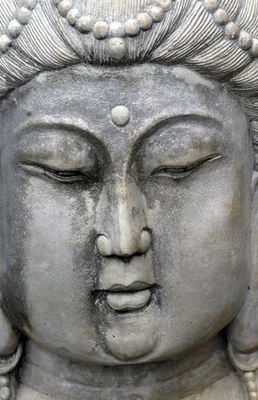 Closeup of concrete statue of woman is unmoving and stone faced  の写真素材