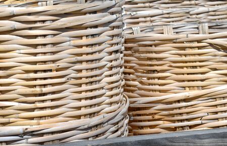 Woven native baskets fill image.  Rustic wooden shelf forms bottom of photograph.