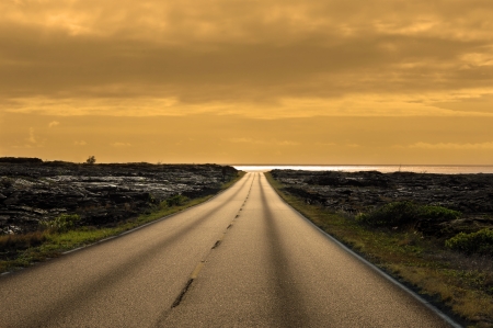 Bend in the road leads to a gorgeous golden sunset.  Life has been full of rocks and barreness.  Bend leads to a new beginning.  This sunset is in Volcanoes National Park on the Big Island of Hawaii.の写真素材
