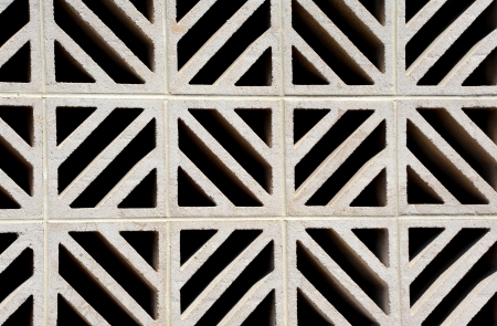 Concrete wall pattern includes diamond, criss-cross and X design.  Wall forms foundation for commercial building.の写真素材